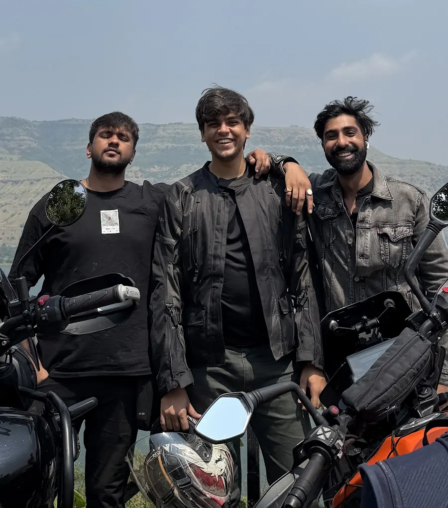 Aditya with riding friends and their motorcycles above a lake